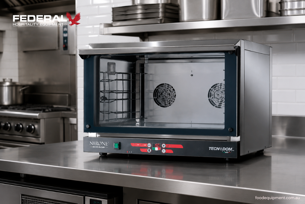 Commercial convection oven with digital controls and fan-assisted cooking chamber in a professional hospitality kitchen.