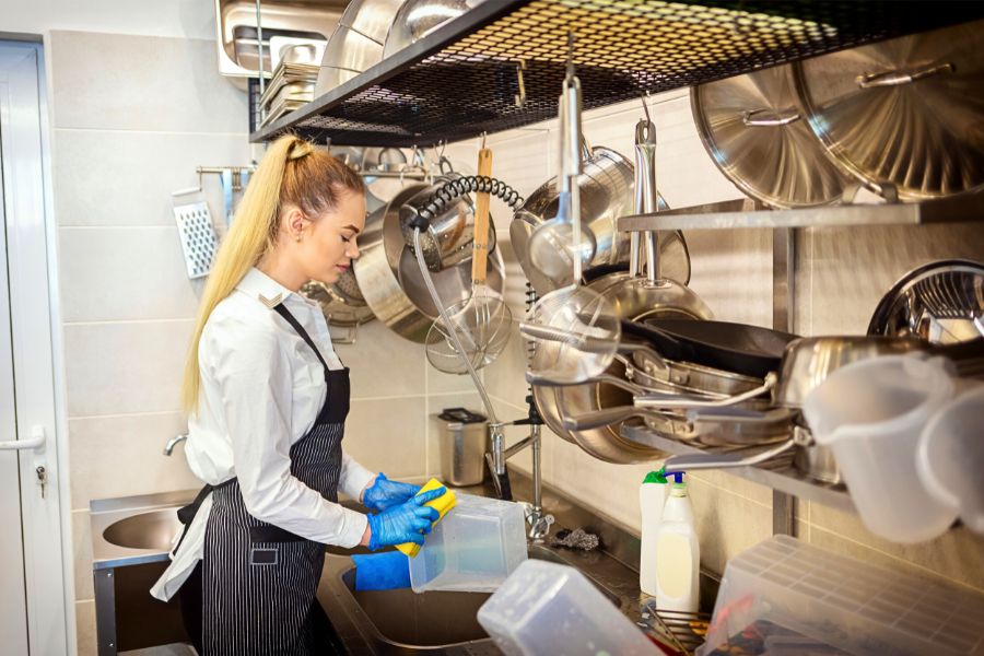 Lady Cleaning Commercial Kitchen Equipment